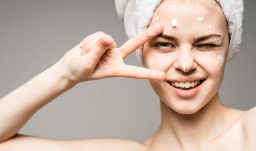 (Skin Health)stock-photo-close-up-of-beautiful-young-woman-applying-cream-with-bath-towel-on-head-covering-her-breasts-on-556550389