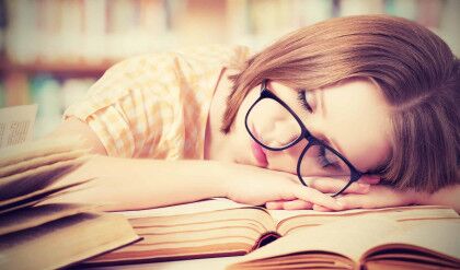 Tired,Student,Girl,With,Glasses,Sleeping,On,The,Books,In